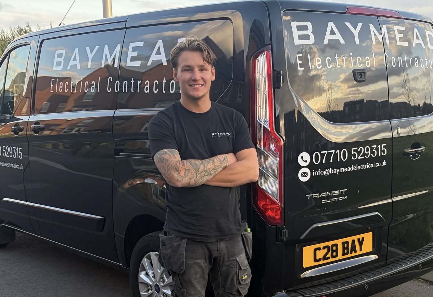 Kane Copsey beside the Baymead Electrical Contractors van