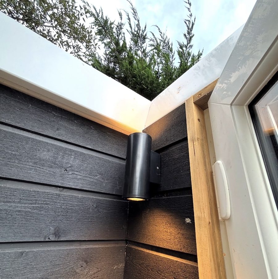Outdoor up-down wall light on black cladding installed by Baymead Electrical Contractors